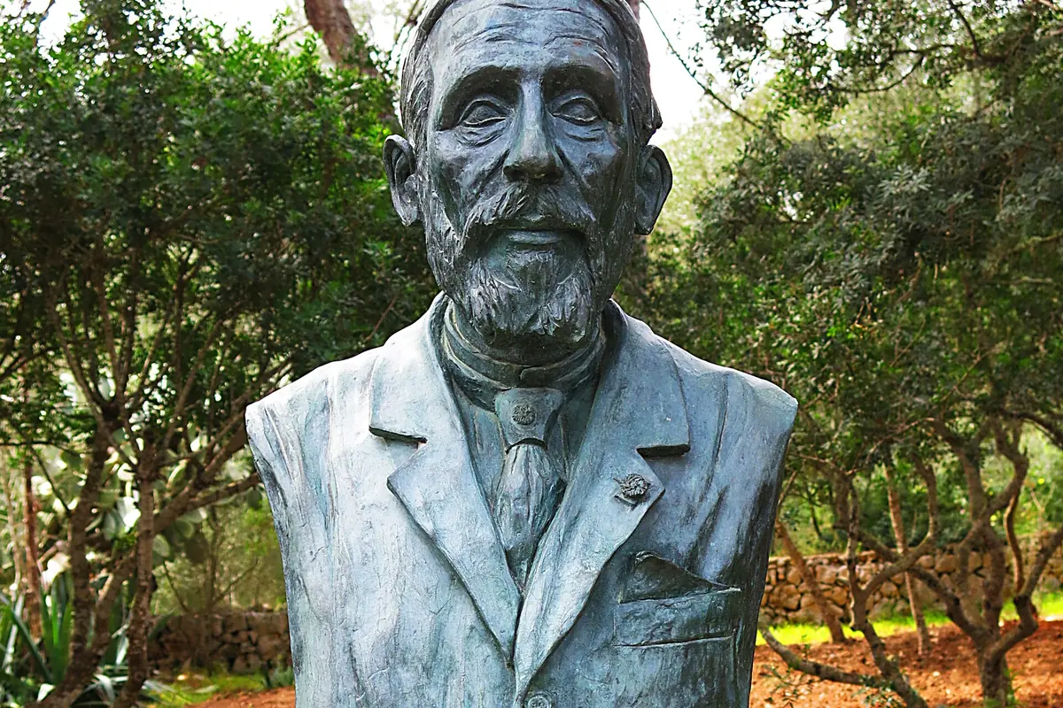 A bronze bust of Édouard-Alfred Martel on a stone plinth near the Drach caves